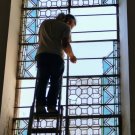 David putting in plexiglass behind panels for temporary protection.